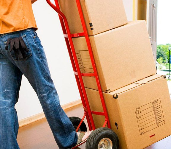 Professional moving service with a worker pushing a cart