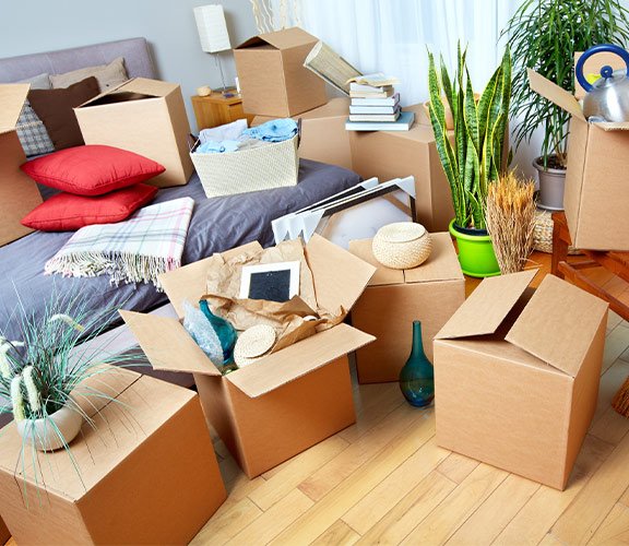 Home relocation scene with belongings packed in cardboard boxes